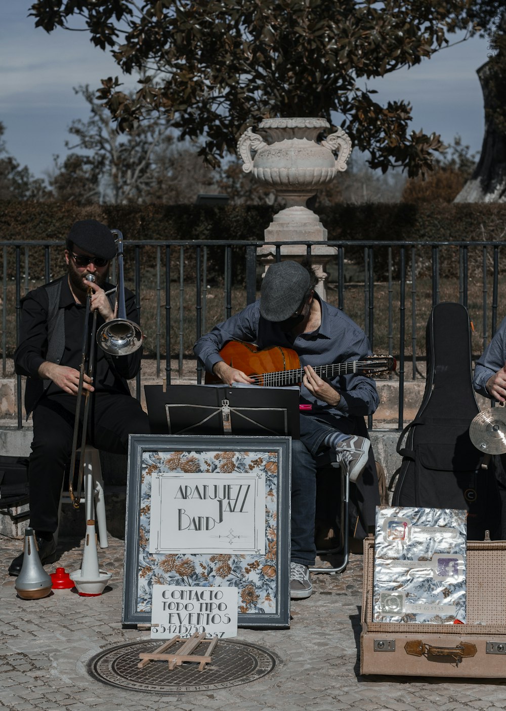 man in blue jacket playing guitar