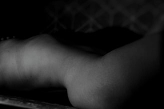 Subtle monochrome photograph of a delicate sculptural form in soft natural light with muted shadows.