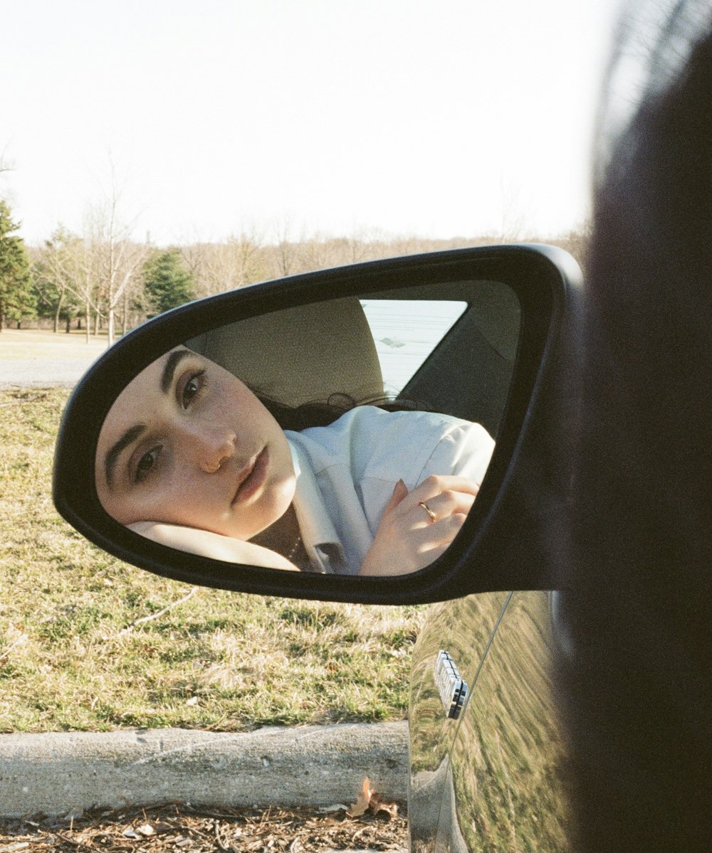 woman in white shirt sitting on car seat