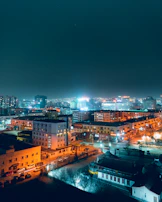Evening cityscape showing residential and commercial buildings illuminated in Vilnius.