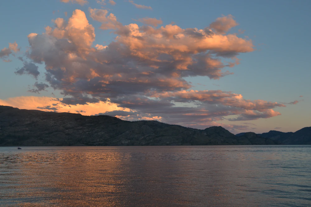 Aerial view of Kelowna, BC with Okanagan Lake and surrounding hills
