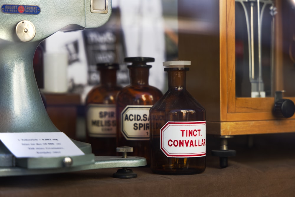 brown glass bottle on brown wooden table