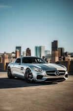Close-up of sparkling clean car surface reflecting the city skyline.