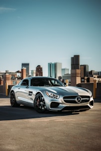 Close-up of sparkling clean car surface reflecting the city skyline.