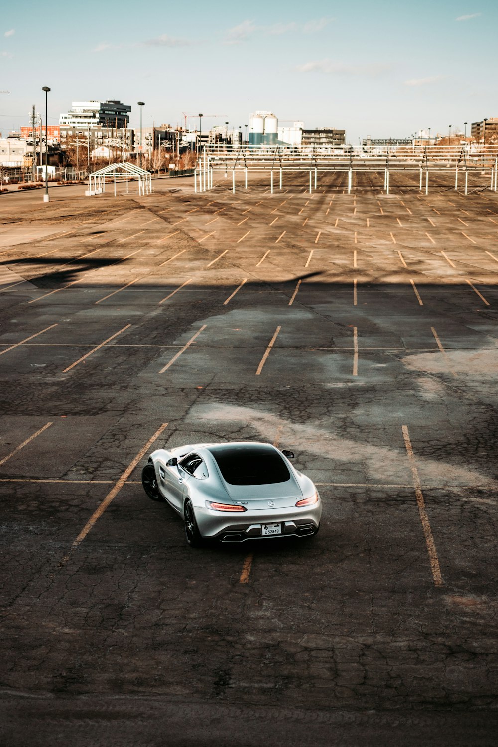 white car parked on parking lot during daytime