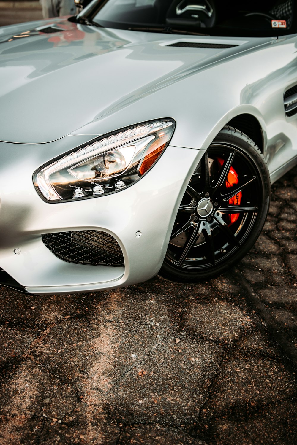 white car on brown and black concrete floor