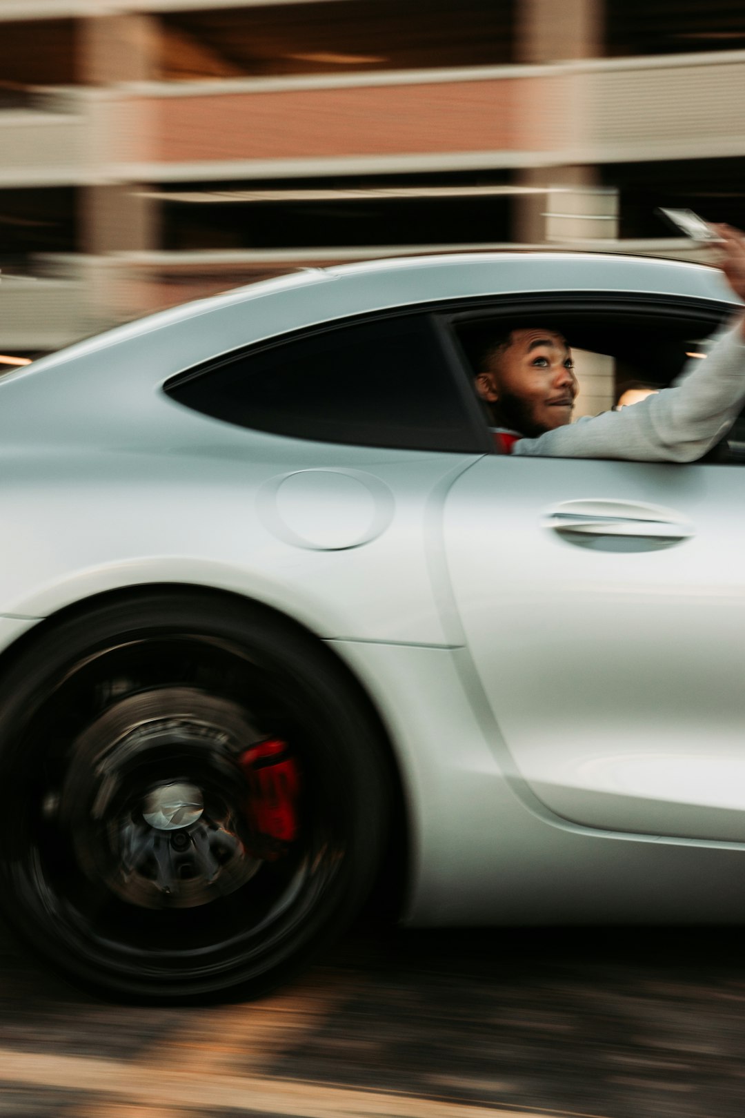 man in white jacket driving white porsche 911