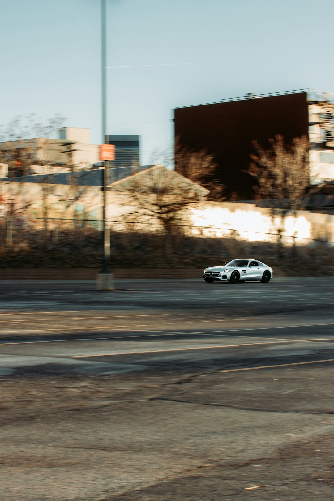 white coupe on gray asphalt road during daytime