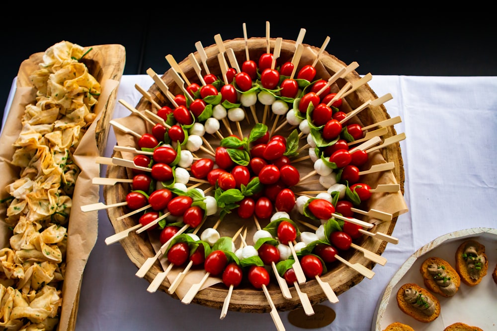 red and white round fruit on brown wooden round plate