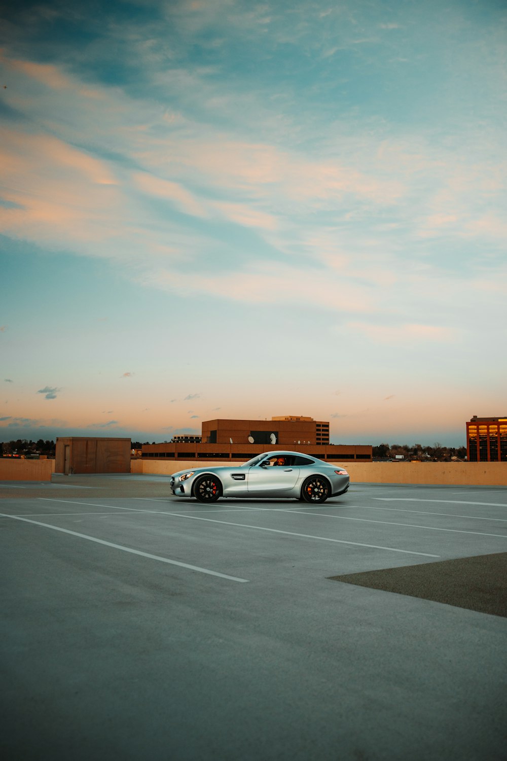 white sedan on gray asphalt road during sunset