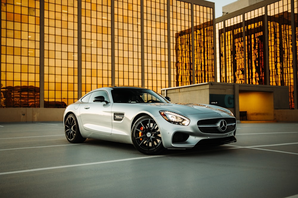 silver mercedes benz coupe parked beside brown brick wall