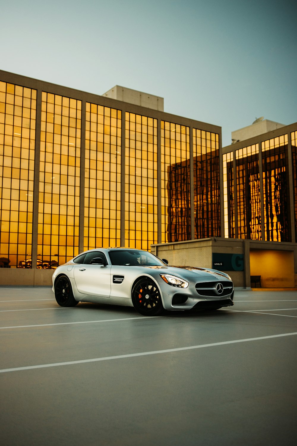 white coupe parked near brown building