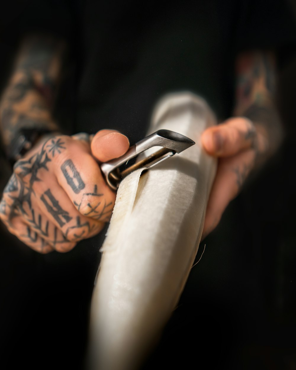 person holding black and silver scissors