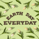 The image features the words 'EARTH DAY EVERYDAY' made from soil or mulch, placed centrally against a pastel green background. Surrounding the text are white tulips with long green leaves, radiating outwards in a pattern.