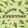 The image features the words 'EARTH DAY EVERYDAY' made from soil or mulch, placed centrally against a pastel green background. Surrounding the text are white tulips with long green leaves, radiating outwards in a pattern.