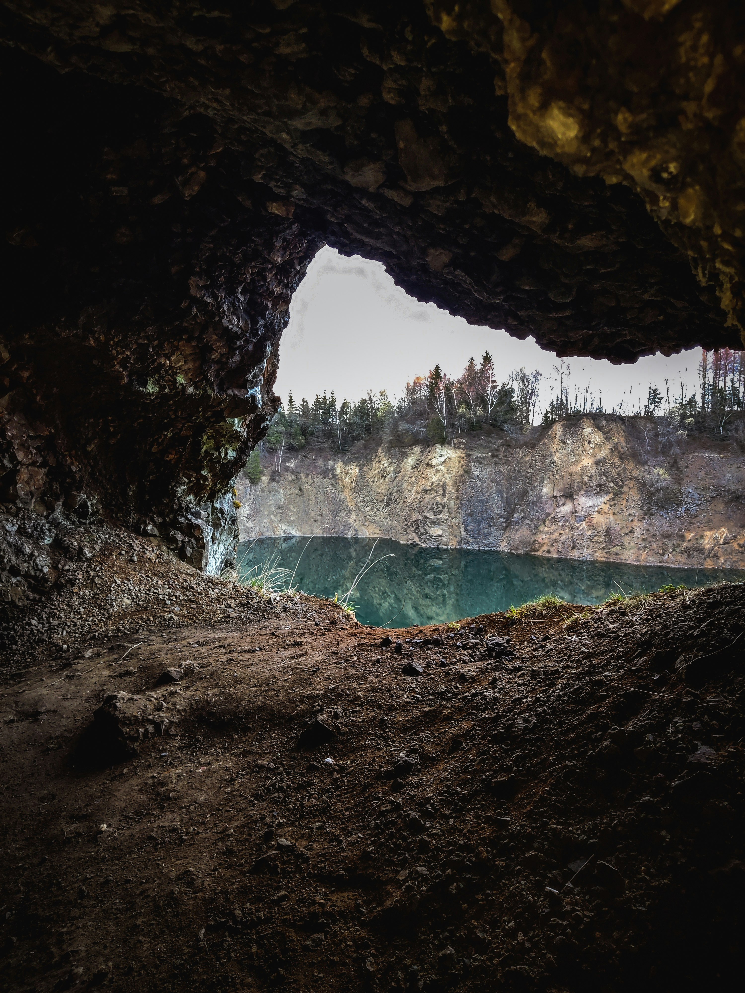 water falls in cave during daytime