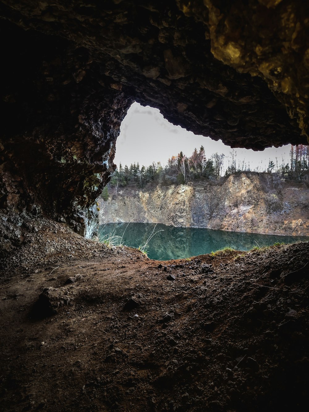 water falls in cave during daytime