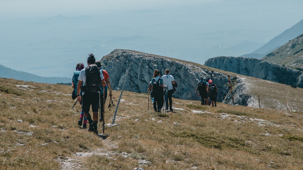 people hiking on mountain during daytime