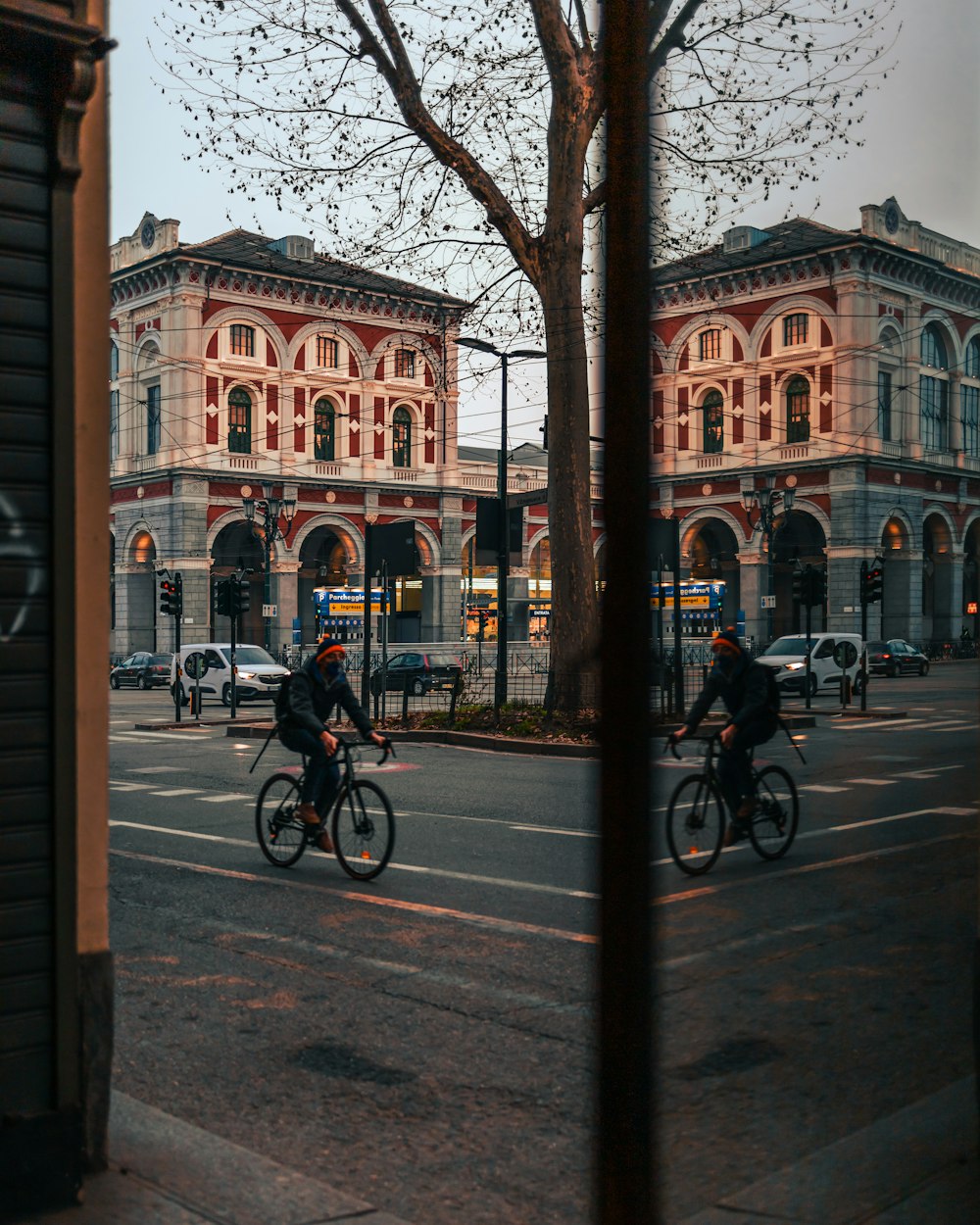 man in black jacket riding bicycle on sidewalk during daytime