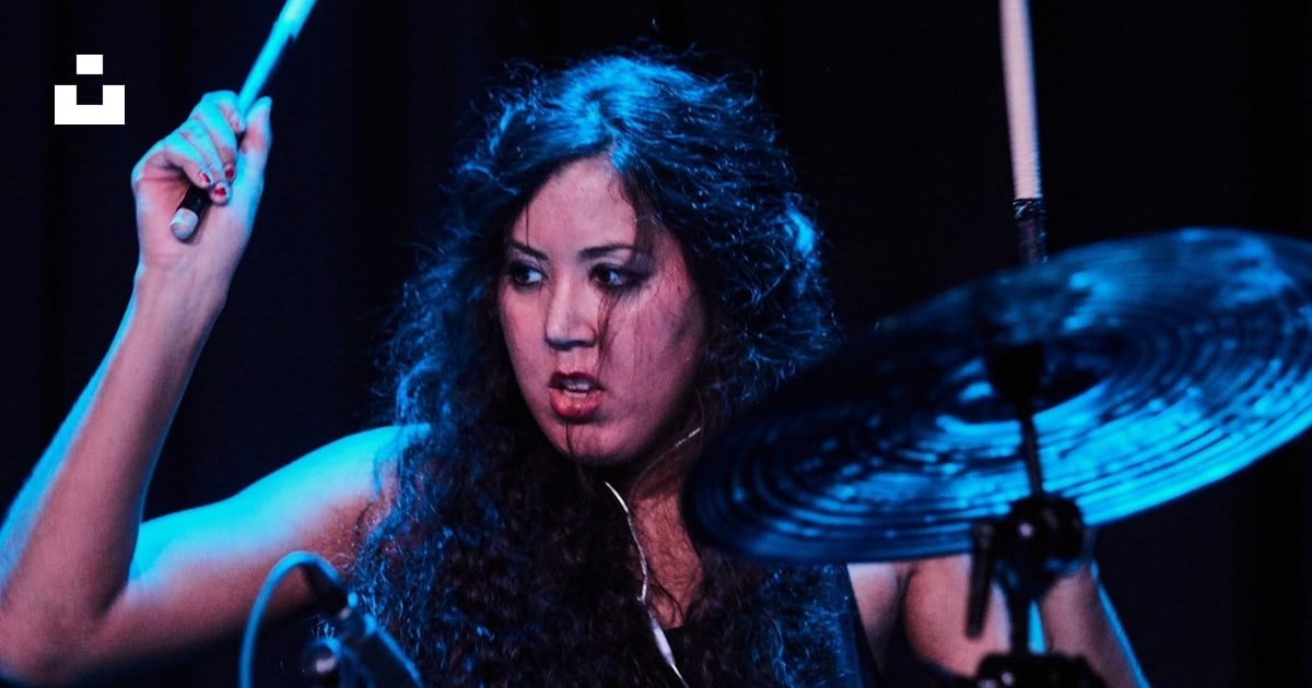 Woman in black sleeveless top playing drum photo – Free Female sound ...