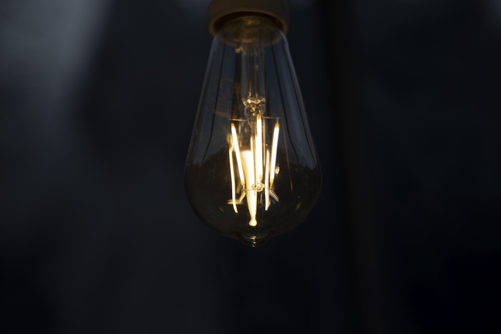 clear glass pendant lamp turned on in dim lit room