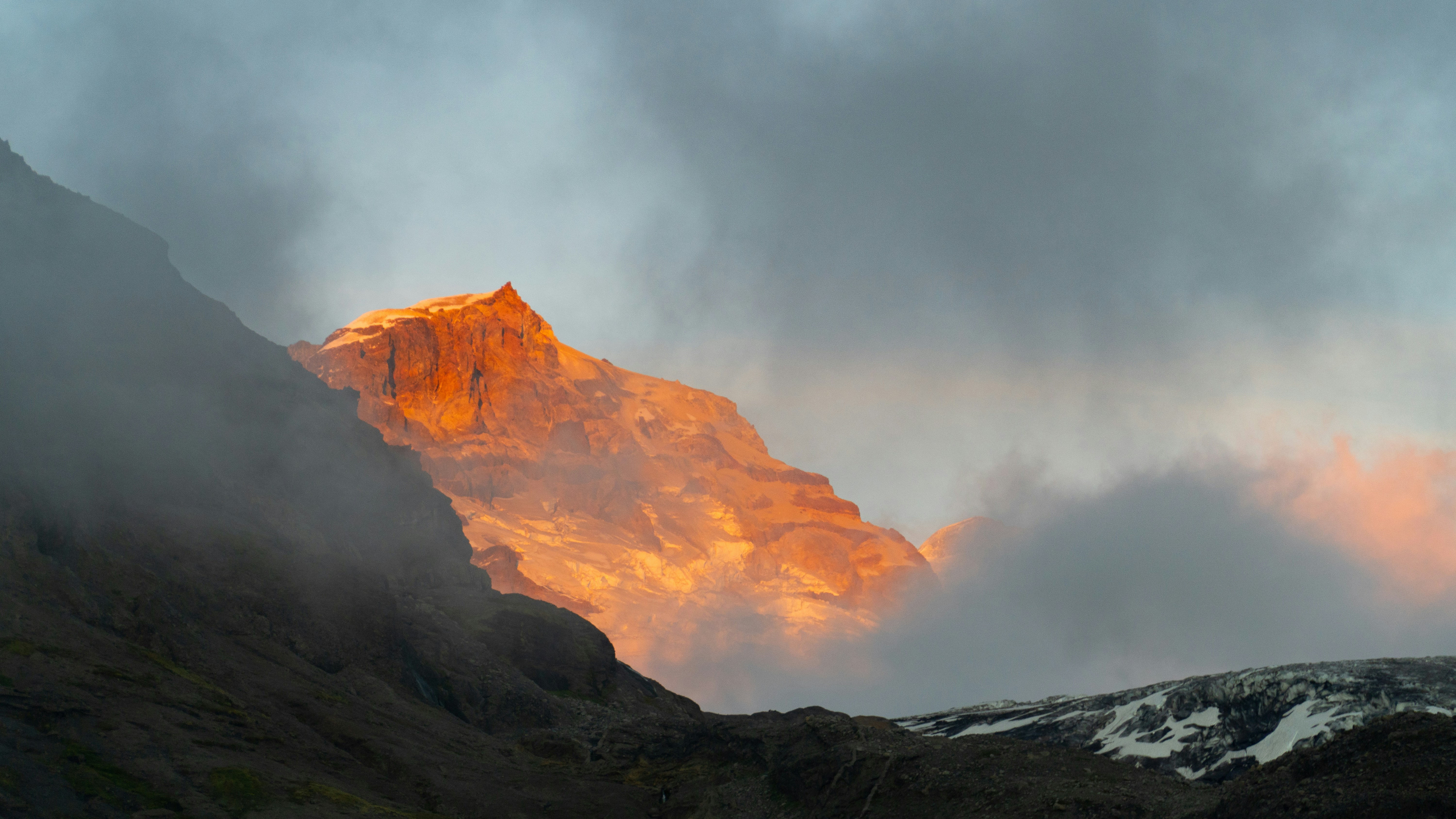 brown mountain under white clouds