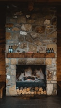 brown brick fireplace with bottles on top