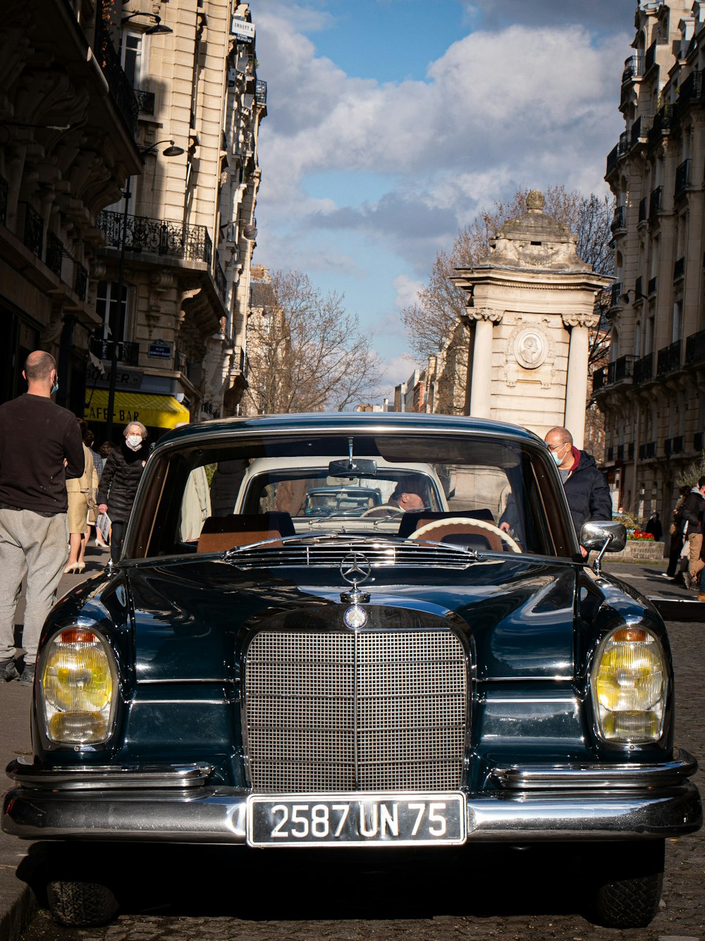 blue classic car on road during daytime