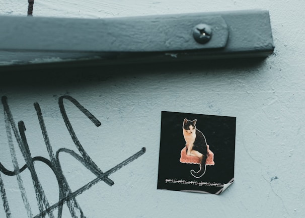 A vibrant sticker featuring a playful cat design.
