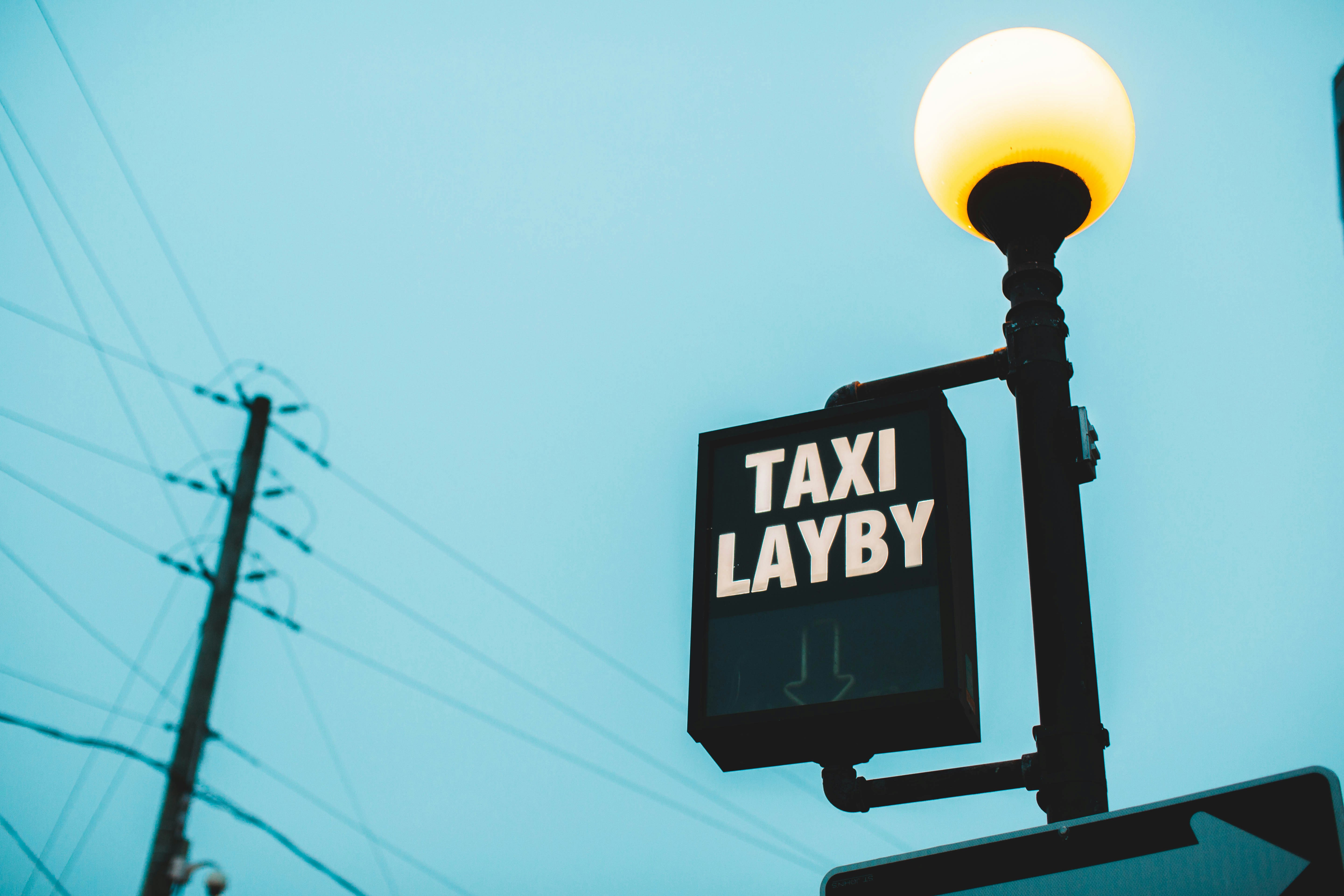 a street light with a sign that says taxi layby