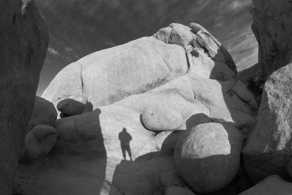 a person standing on top of a large rock