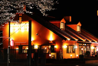 Softly lit building facade with warm white lights enhancing the evening ambiance.