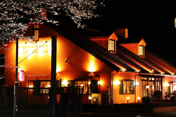 A cozy community center with warm golden lights glowing in the evening.