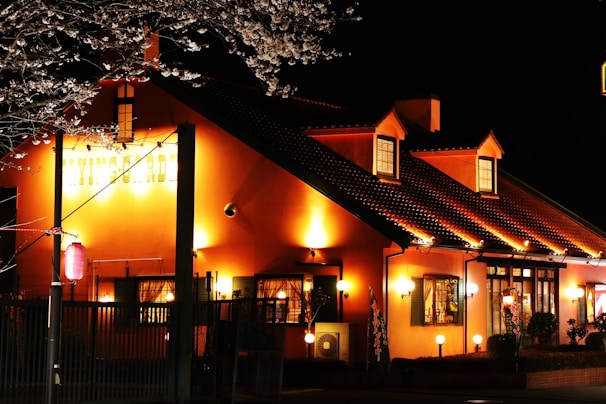 Night view of the building facade illuminated with warm lighting, inviting and secure