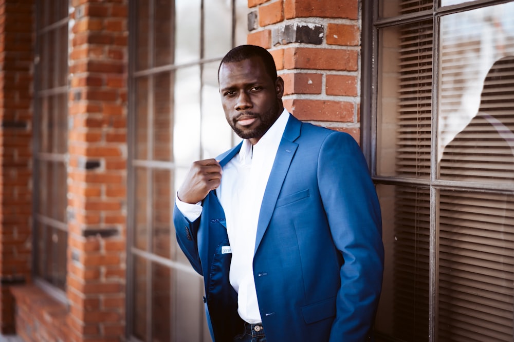 man in blue suit jacket and white dress shirt