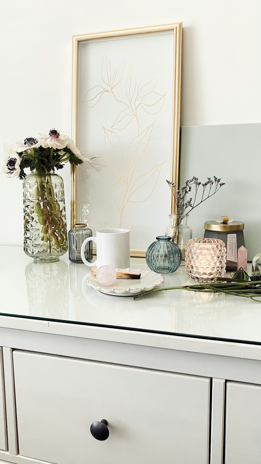 white ceramic mug on white ceramic plate beside white ceramic plate on white table