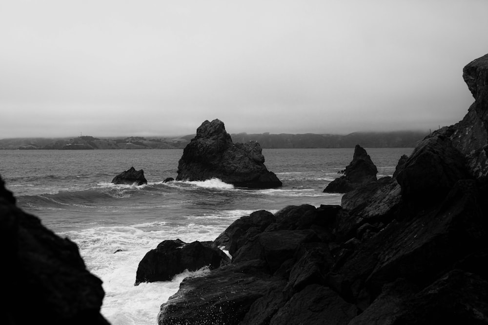 grayscale photo of rocky beach