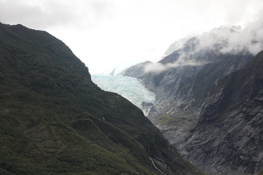 green and gray mountains under white sky during daytime