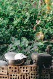 A rustic kitchen scene featuring ceramic bowls and wooden utensils.