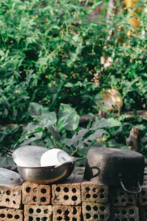 Bronze cookware arranged with Bronze Age inspired pottery and natural elements for a timeless feel