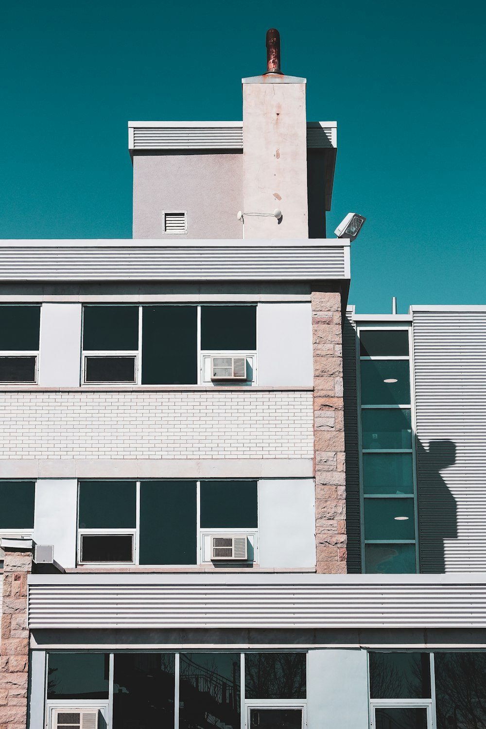 brown and white concrete building under blue sky during daytime