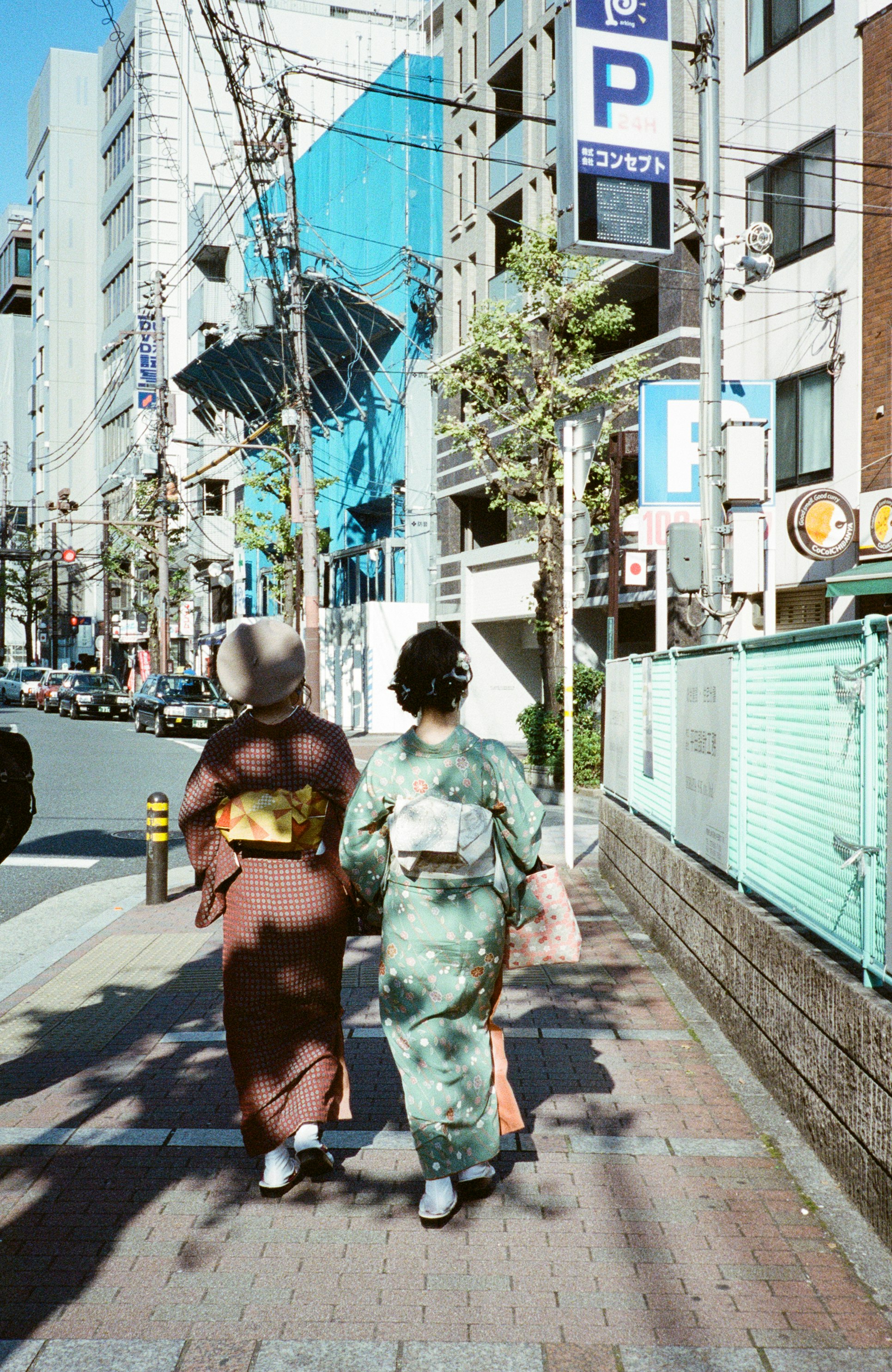 2 women in kimono standing on pedestrian lane during daytime