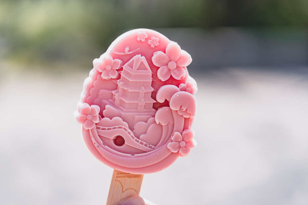 pink lollipop on brown wooden stick