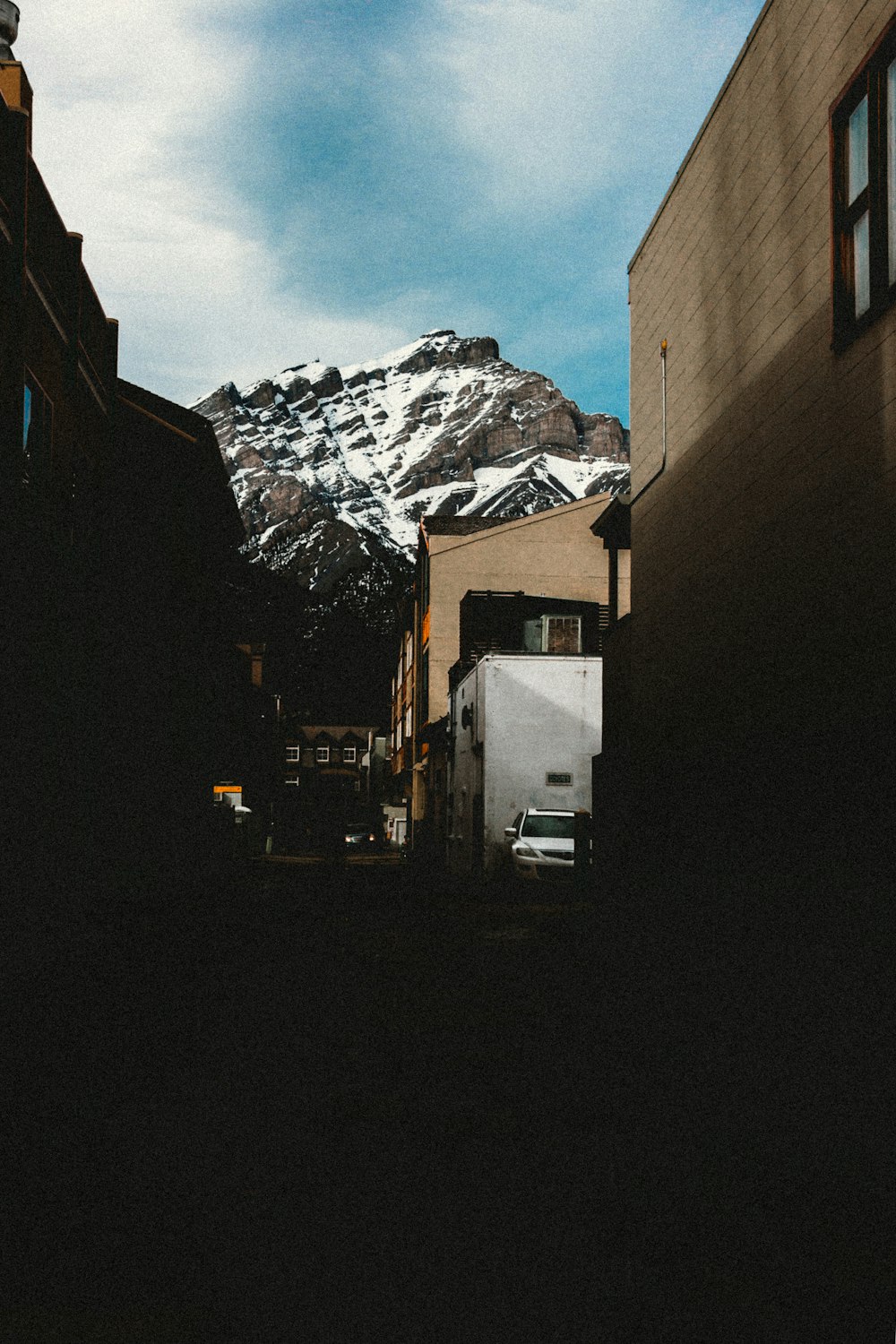 white and brown concrete building near mountain during daytime