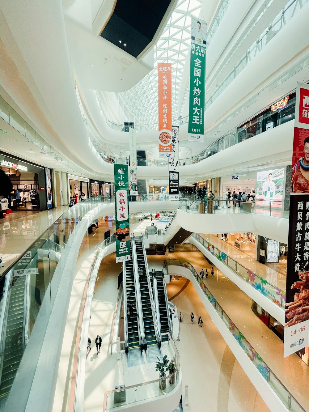 people walking inside building with escalator