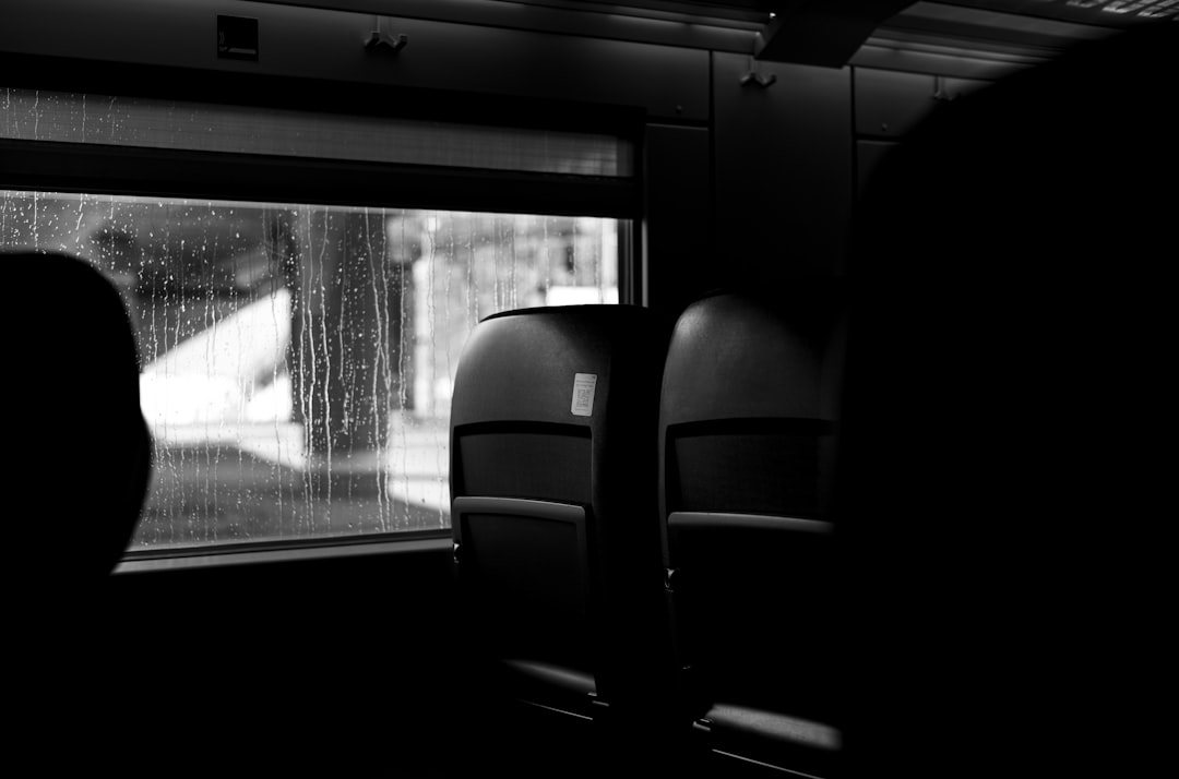 black leather car seat near window, Pandemic Times: Empty Train in the Rain.