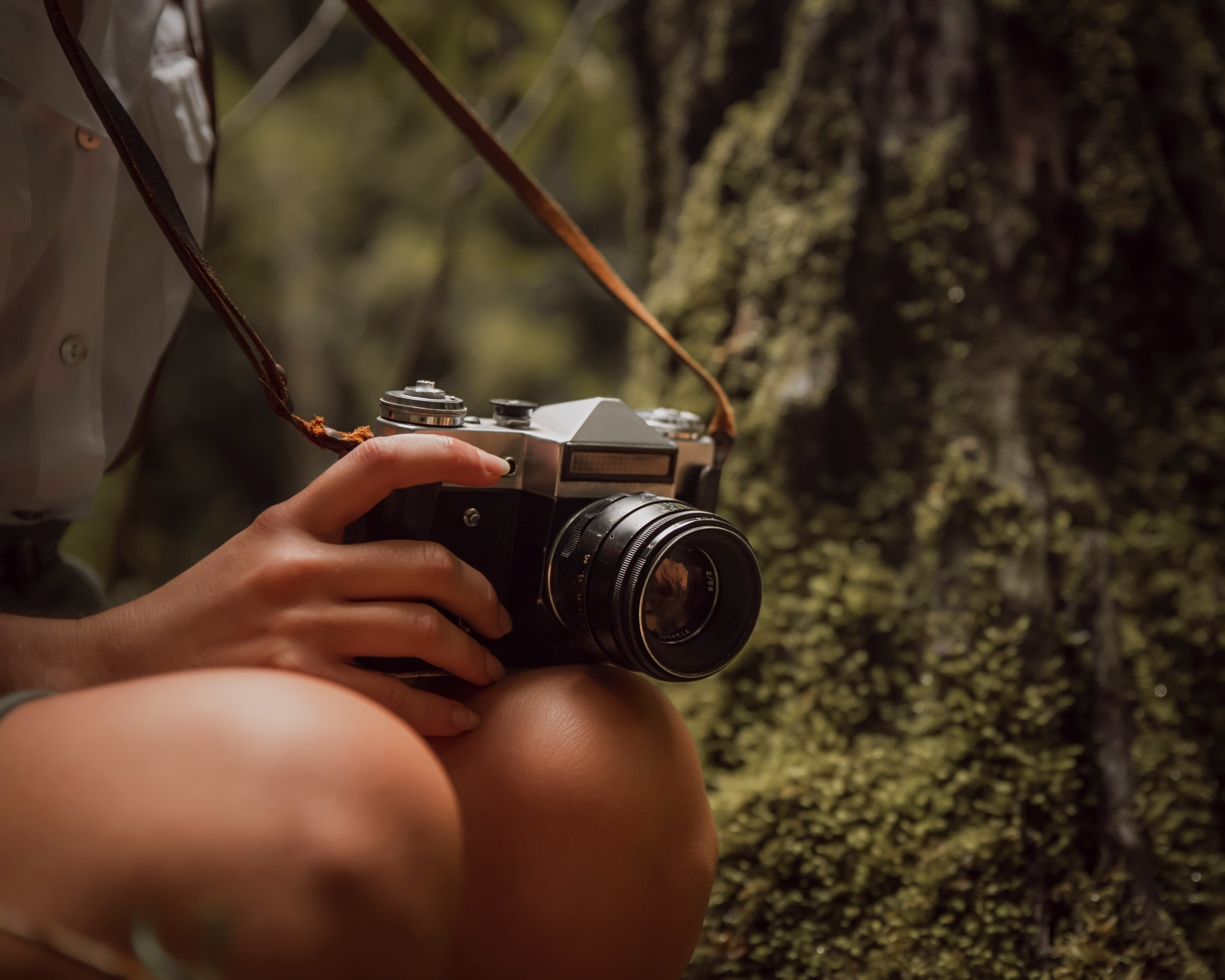 person holding black and silver dslr camera