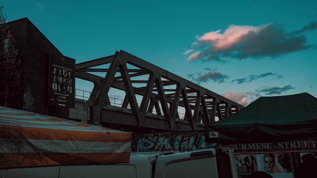 white crew cab pickup truck under bridge during daytime