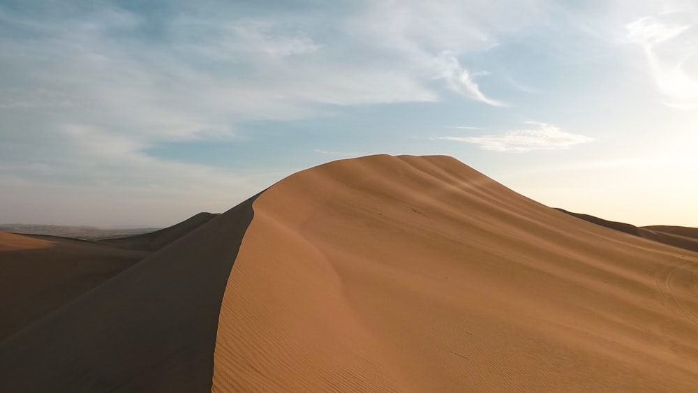 brown sand under blue sky during daytime