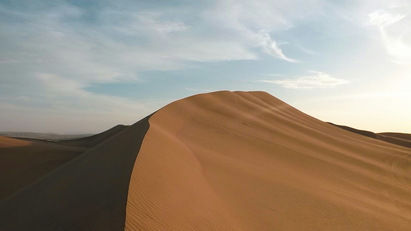 Late afternoon gives the dunes softer light and cooler sand
